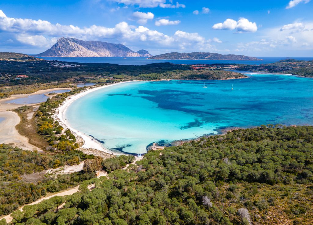 Luxury Sardinia yacht charter turquoise bay aerial view luxury beach Italy