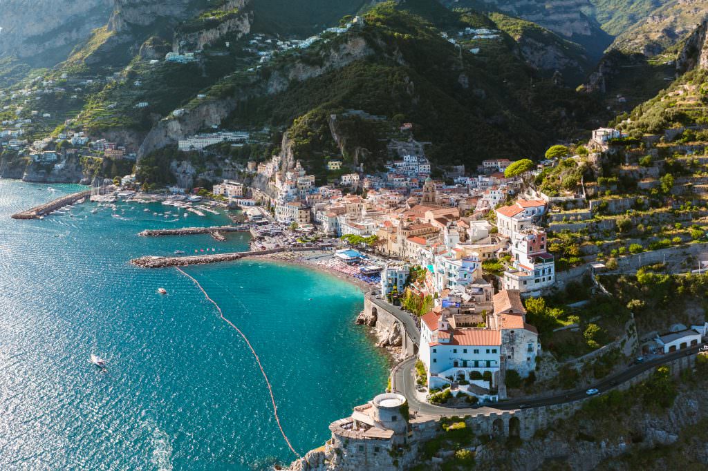 Amalfi yacht charter in Amalfi Coast Italy with coastal town and turquoise sea view