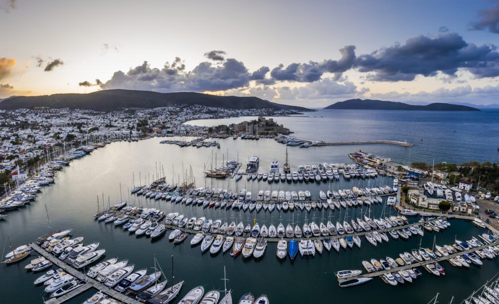 Bodrum marina yacht charter Turkey luxury yachts harbor sunset coastal town