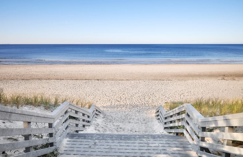 Hamptons yacht charter beach wooden pathway New York USA