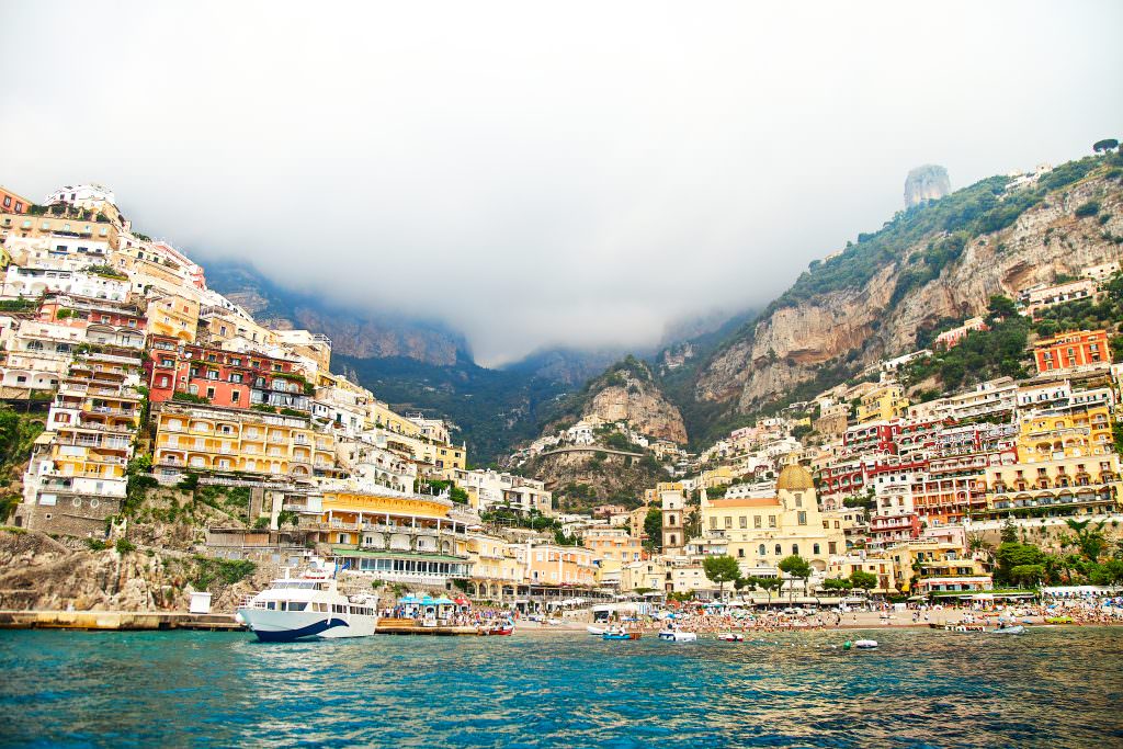 Positano yacht charter at beach cliffside town Amalfi Coast Mediterranean luxury yacht charter destination Italy