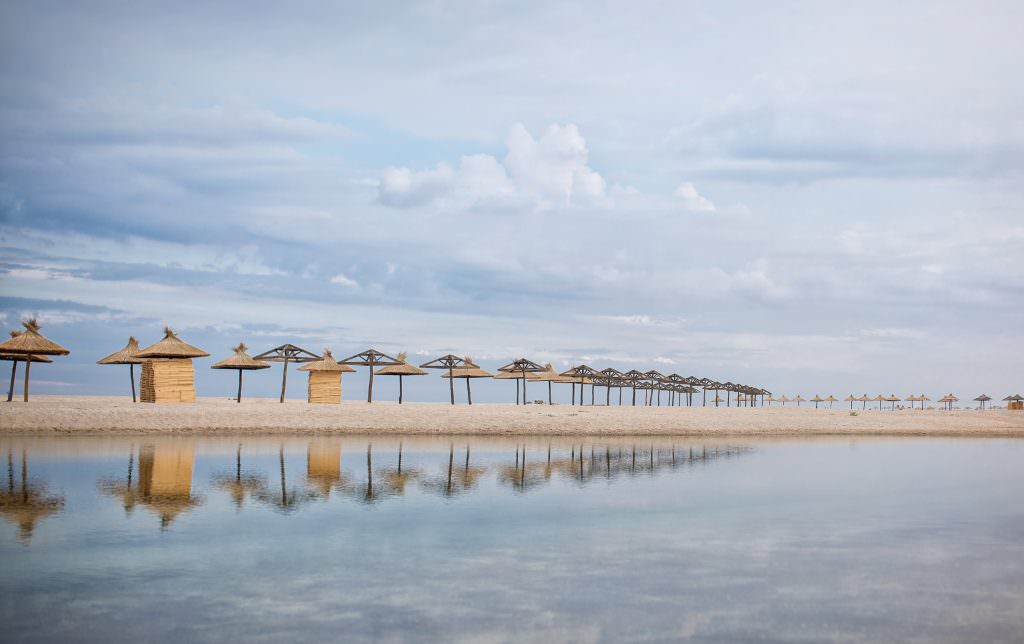 Luxury Saadiyat Island yacht charter beach with umbrellas and tranquil coastline Abu Dhabi