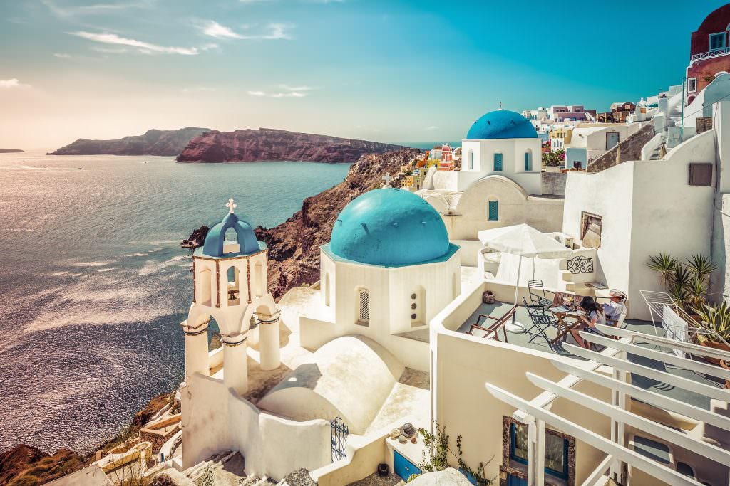 Santorini to Milos yacht charter itinerary blue domes Santorini Cyclades Greece sea view