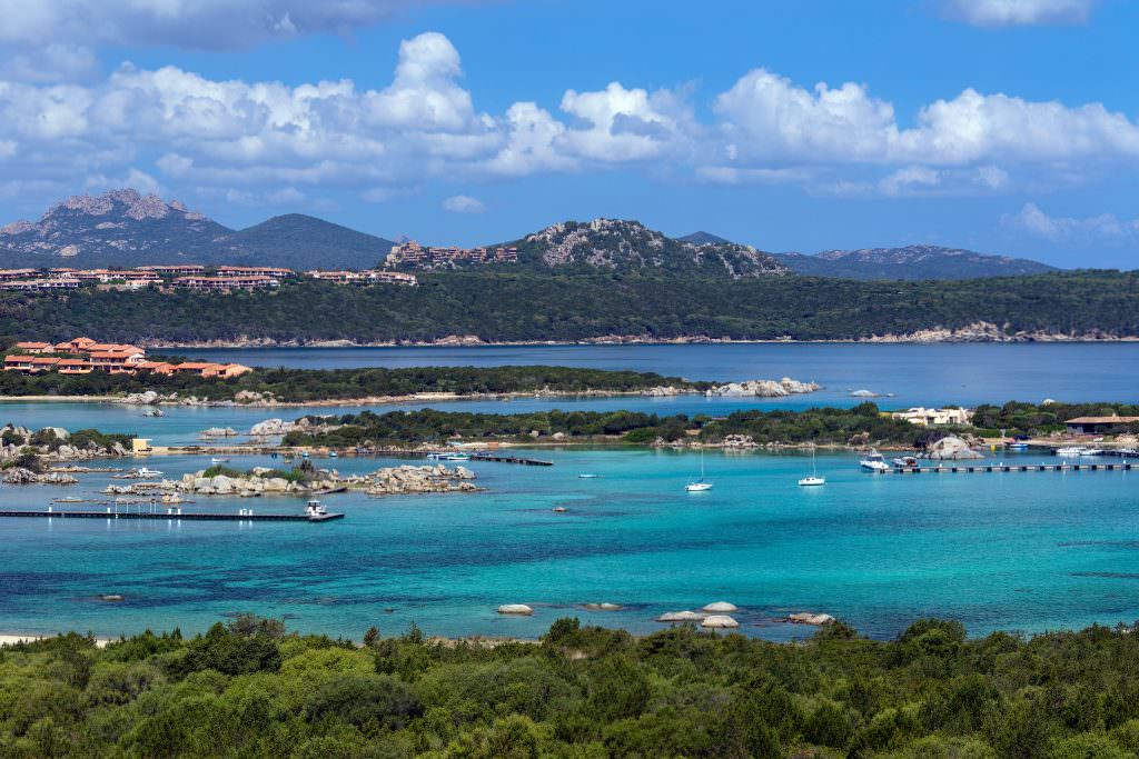 Luxury yacht charter in Sardinia with turquoise lagoon and crystal clear Mediterranean waters