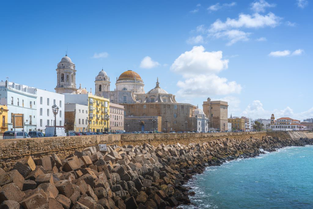 Luxury Sicily yacht charter with historic coastal city and Mediterranean harbor view Italy