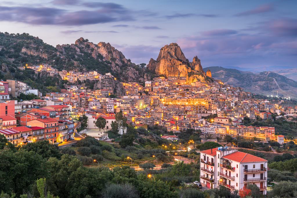 Luxury yacht charter in Sicily with scenic mountain town and sunset view historic village Italy