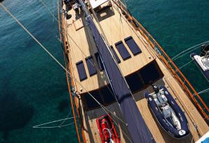 Clear Eyes gulet deck aerial view, luxury gulet yacht with teak deck, sun loungers, tender boats and premium outdoor living space in crystal clear waters
