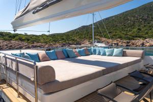 De Love motor sailer sundeck lounge area with panoramic sea views, luxury yacht charter outdoor relaxation space with comfortable seating