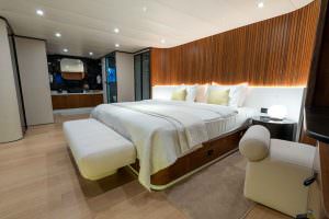 De Love motor sailer VIP cabin interior with elegant wood design, spacious luxury yacht charter bedroom with modern lighting and ensuite area