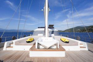 King of the Sea motor sailer front deck lounge, luxury yacht sunbathing and relaxation area with sea view and premium charter experience