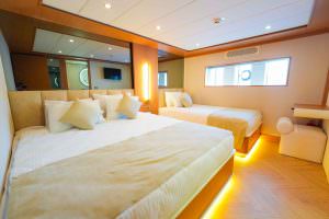 King of the Sea motor sailer twin cabin, luxury yacht guest bedroom with elegant design, twin beds and ambient lighting for comfortable stay