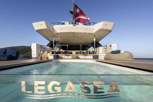 Legasea luxury yacht aft deck swimming pool with lounge seating and open sea view