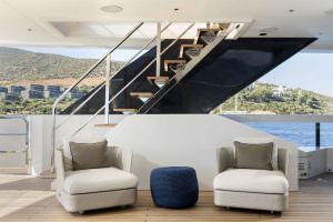 Legasea luxury yacht deck lounge with modern armchairs and staircase access overlooking the sea