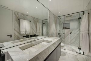 Legasea luxury yacht marble bathroom with modern sink, glass shower and elegant interior design