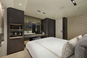Legasea luxury yacht cabin interior side view with double bed, mirror and modern furniture design