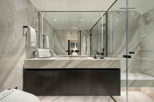 Legasea luxury yacht bathroom with marble vanity, large mirror, modern sink and glass shower cabin