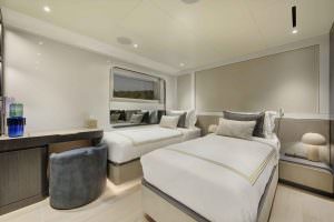 Legasea luxury yacht twin guest cabin with two single beds, elegant design, soft lighting and modern interior