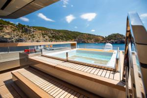 Luxury yacht Maverick deck jacuzzi with panoramic sea and coastline view