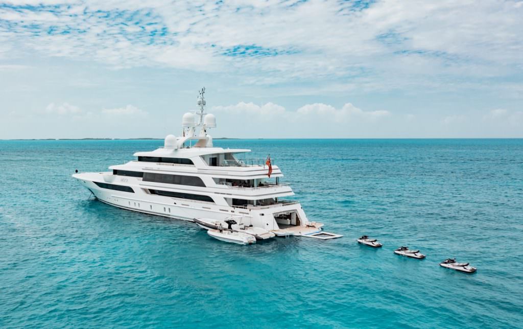 Luxury yacht MOCA aerial view with jet skis and water toys in turquoise sea