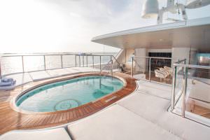 Luxury yacht MOCA jacuzzi deck with panoramic ocean view and sun loungers