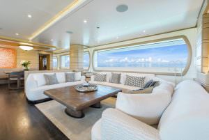 Luxury yacht MOCA main salon lounge with panoramic sea view and large seating area