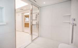 Luxury yacht MOCA spacious shower room with modern glass cabin and minimalist design