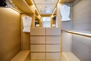 Luxury yacht MOCA walk-in closet with drawers, hanging space and premium interior lighting