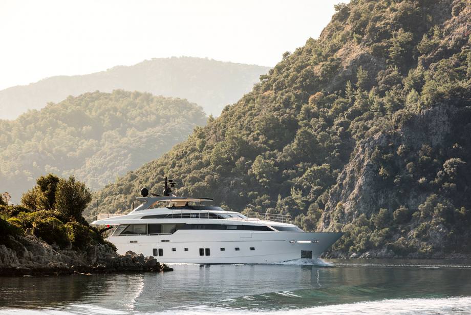 Morning Star yacht charter cruising in a secluded bay surrounded by green mountains