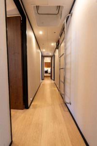 De Love motor sailer interior corridor, luxury yacht charter design with modern hallway, wooden flooring and soft lighting