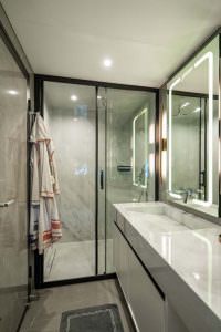 North Wind motor sailer bathroom, luxury yacht modern bathroom with glass shower, elegant sink and illuminated mirror design