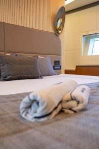 North Wind motor sailer cabin bed detail, luxury yacht interior with premium bedding, elegant design and refined comfort atmosphere