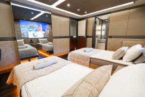 North Wind motor sailer twin cabin interior, modern luxury yacht bedroom with twin beds, elegant lighting, mirrored wall design and premium comfort layout