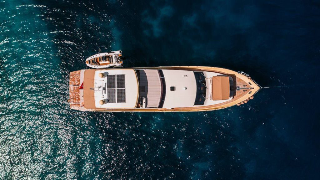 Aerial top view of Reis luxury yacht at sea, premium yacht charter experience