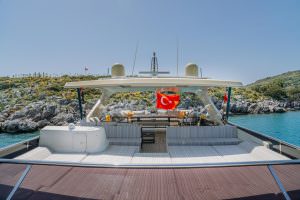 Reis yacht aft deck seating area with Turkish flag, luxury yacht charter experience