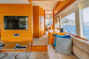 Reis yacht salon interior with sea view windows, luxury yacht charter experience